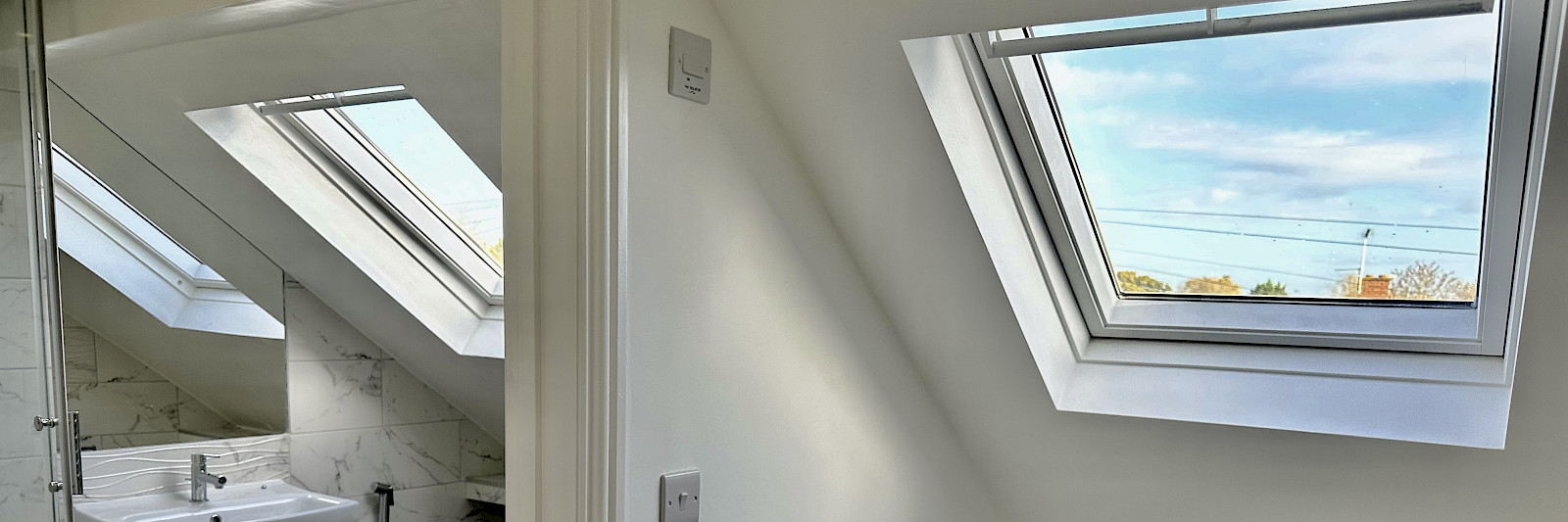 Interior view of a loft with a beautifully designed dormer window, filling the space with natural light and enhancing the overall aesthetic. Perfect for loft conversion and interior design inspiration.