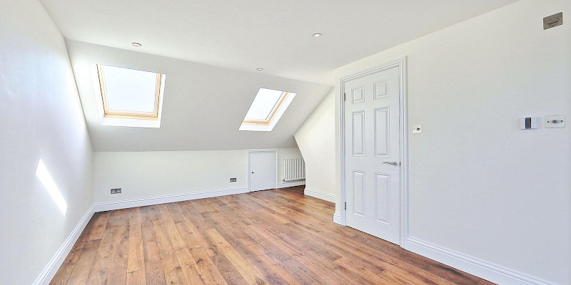 Spacious bedroom with beautiful wooden pine floors and plenty of natural light, thanks to large Velux windows.