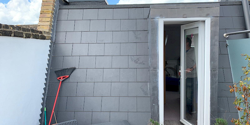 Exterior view of a completed mansard loft conversion, featuring a sleek and stylish design. The modern extension blends seamlessly with the existing structure, adding both character and space to the home.