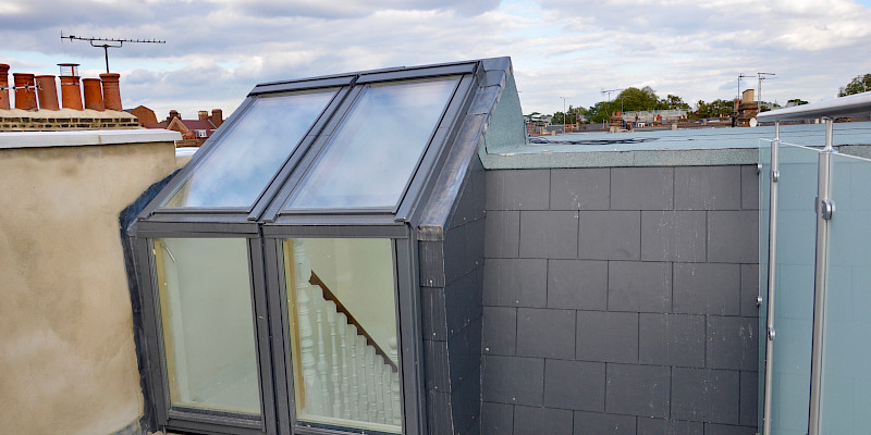 Stunning roof terrace with Velux windows offering seamless access to a staircase, providing a perfect blend of indoor-outdoor living. Ideal for loft conversion and home extension inspiration.