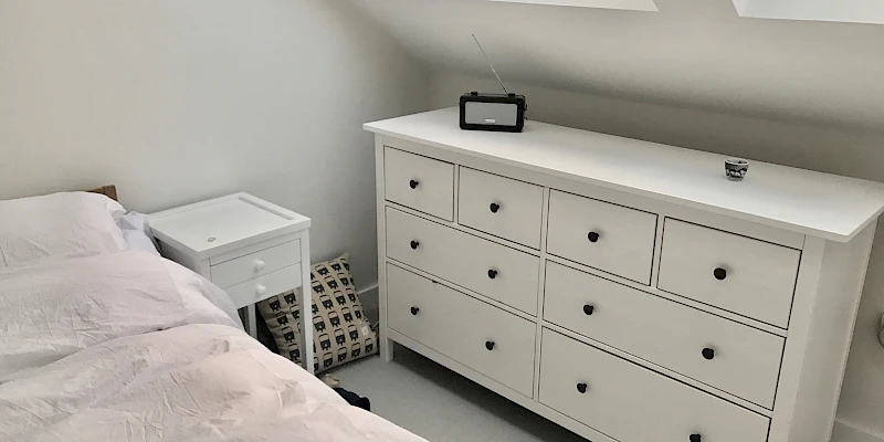 Charming and light-filled loft bedroom with two Velux skylights, creating a warm and inviting atmosphere. The strategically placed windows allow natural light to pour in, making the space feel open and airy.