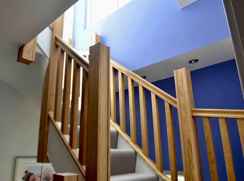 Chic staircase leading to a loft, featuring rich blue walls that add a bold touch of color.